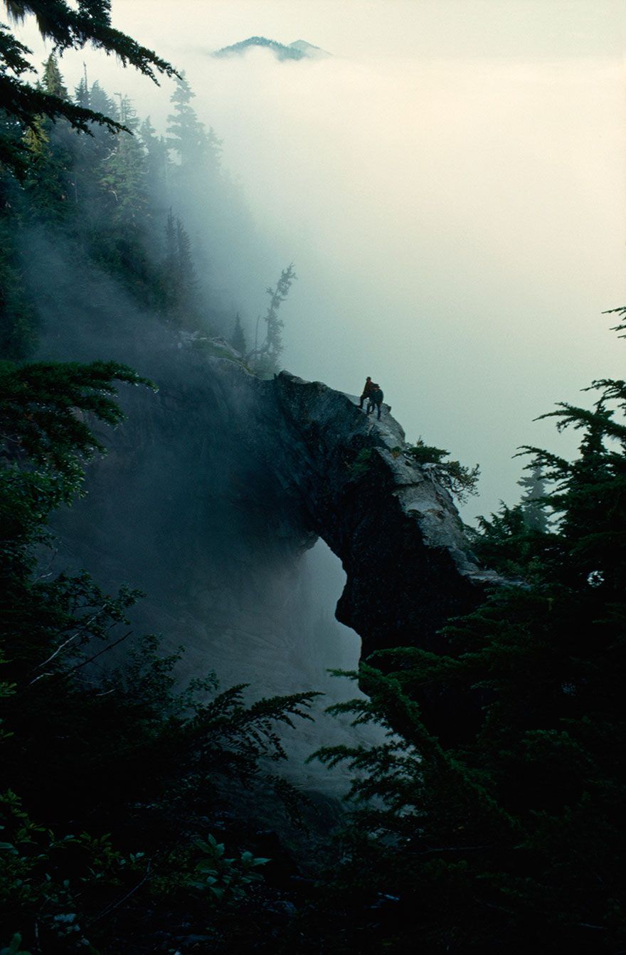 Hikers Stand Near The Top Of A Natural Rock Bridge On Mt. Rainier, Washington, May 1963